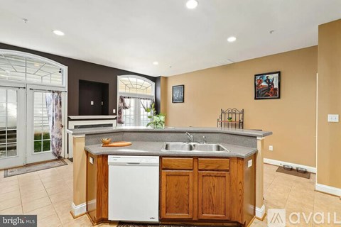 A kitchen with a white dishwasher and a wooden counter.