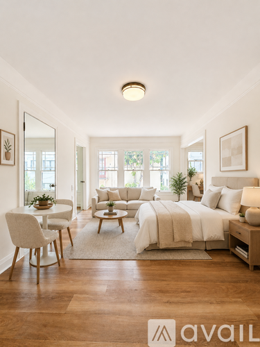 A bedroom with a bed, chair, and table.