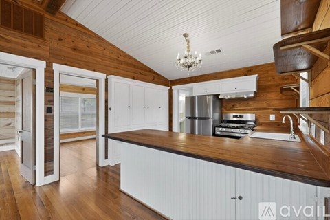 A kitchen with wooden cabinets and a white countertop.