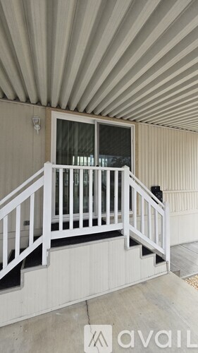 A balcony with white railings and a window.