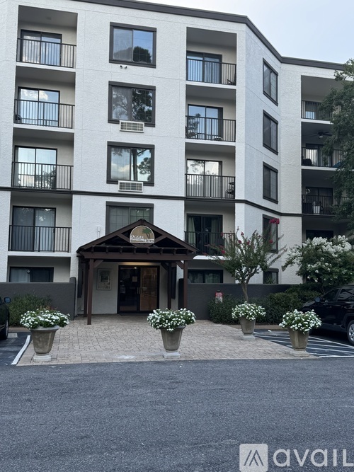 A building with a front entrance and flower pots in front.