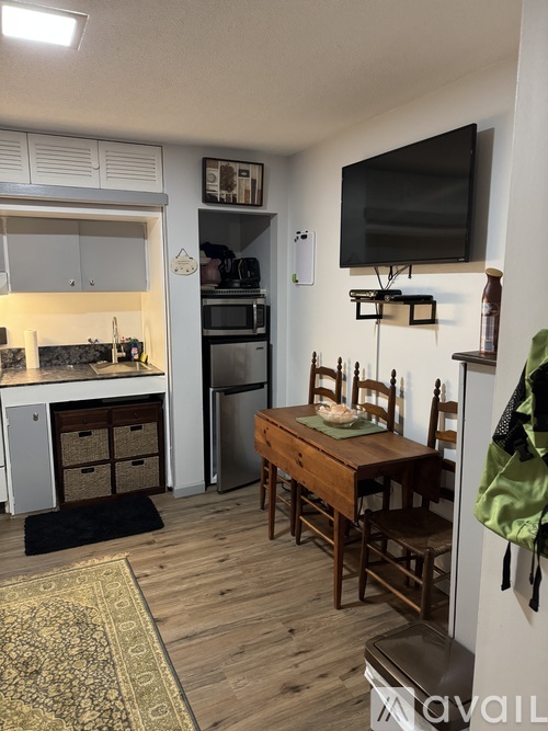 A kitchen with a table and chairs in the middle of the room.