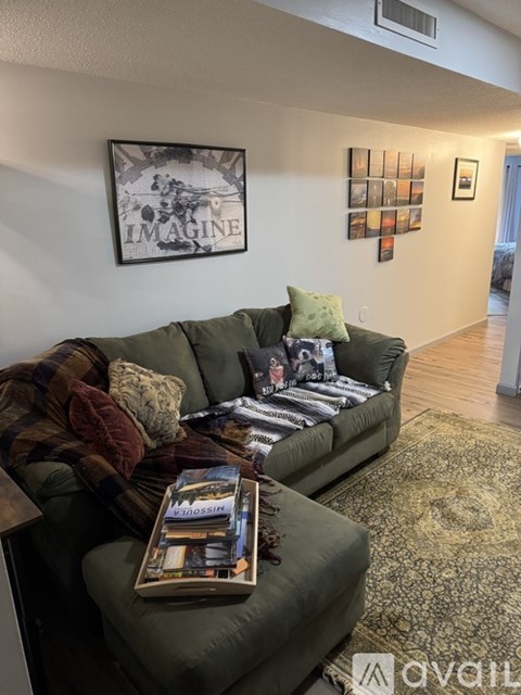 A living room with a couch and a book on it.