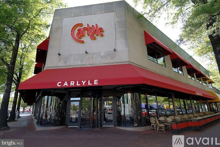 A Carlyle restaurant with a red awning and a sign on the building.