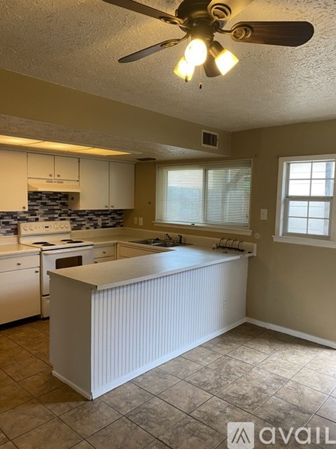 A kitchen with a white island in the middle.