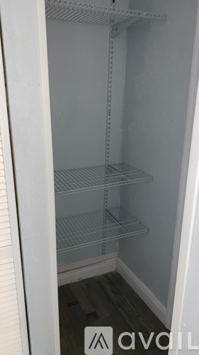 Empty white refrigerator with a sign on the door.