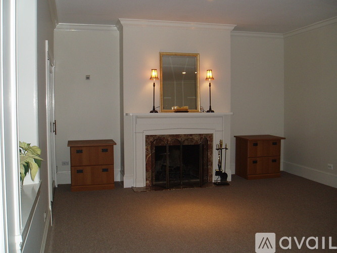 A living room with a fireplace and two lamps.