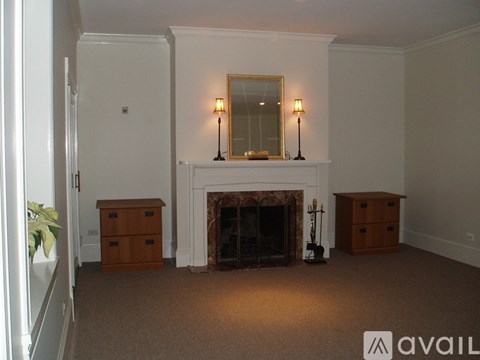 A living room with a fireplace and two lamps.
