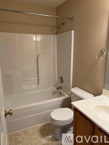 A bathroom with a toilet, sink, and bathtub.