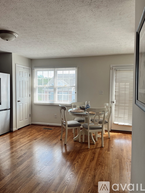 A dining room with a table set for four.