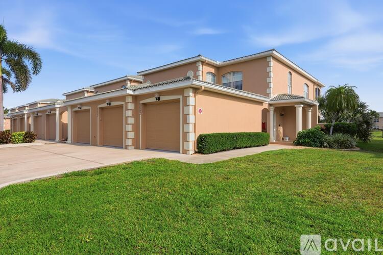 A large house with a beige exterior and a red "available" sign in front.