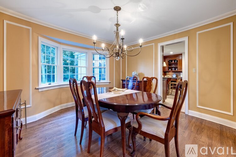 A dining room with a table set for six.