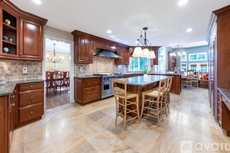 A kitchen with wooden cabinets and a large island.