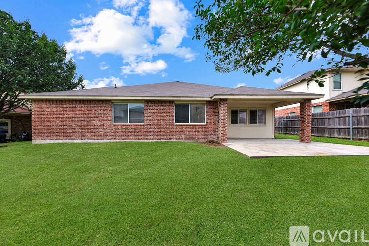 A house with a brown brick exterior and a grey roof.