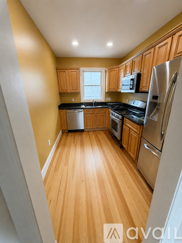 A kitchen with wooden cabinets and stainless steel appliances.
