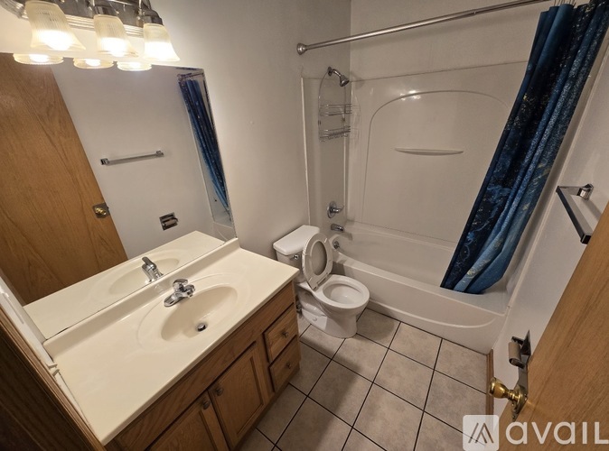 A bathroom with a sink, toilet, and bathtub.