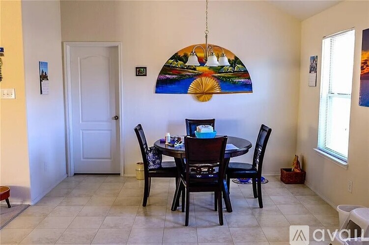 A dining room with a table set for four.