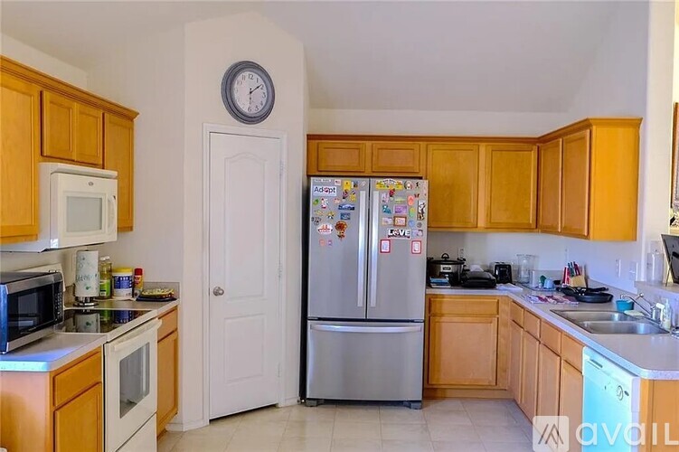 A kitchen with wooden cabinets and a white refrigerator.