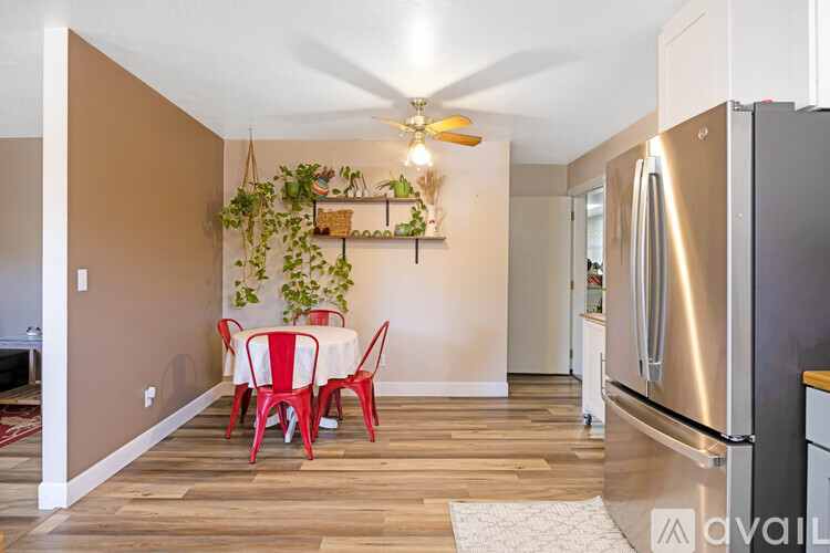 A kitchen with a table and chairs in the middle of the room.