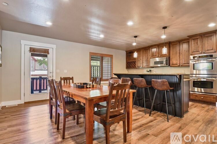 A kitchen with a table and chairs in the middle of the room.