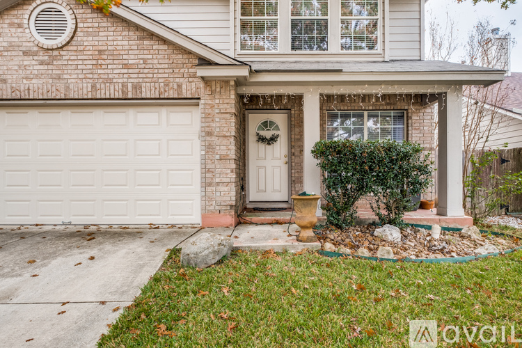 A house with a white garage door and a wreath on the door.