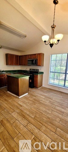 A kitchen with wooden cabinets and a green countertop.