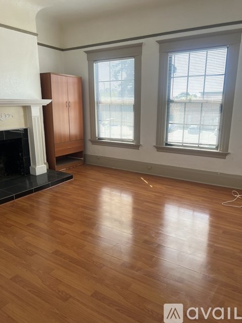 A room with a fireplace and wooden floors.