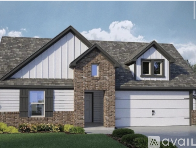 A modern house with a garage and a brick chimney.