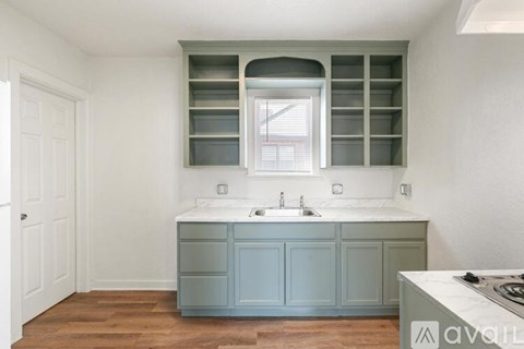 A kitchen with a sink and a cabinet.