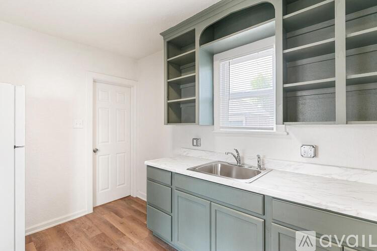 A kitchen with a sink and cabinets.