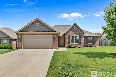 A house with a brown roof and a garage door is for sale.
