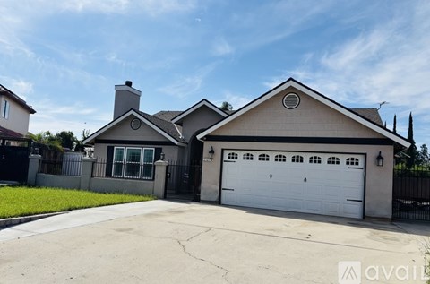 A two-story house with a garage is for sale.