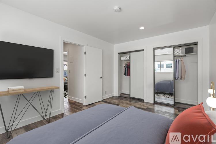 A bedroom with a bed, a television, and a wardrobe.