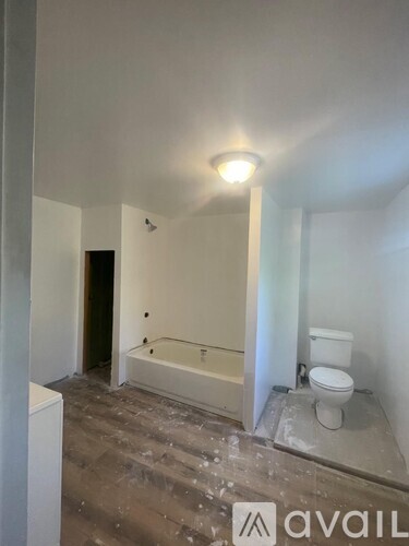 A bathroom under renovation with a toilet and a bathtub.