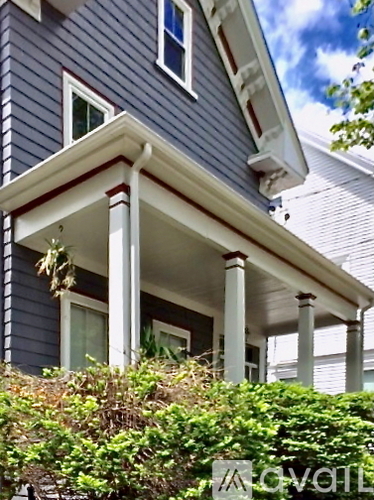 A house with a blue siding and white trim.