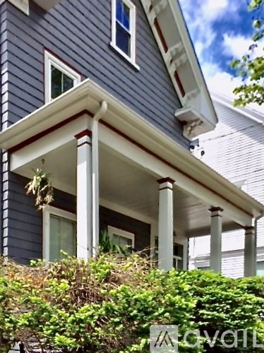 A house with a blue siding and white trim.