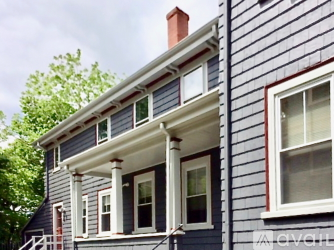 A house with a blue siding and white trim.