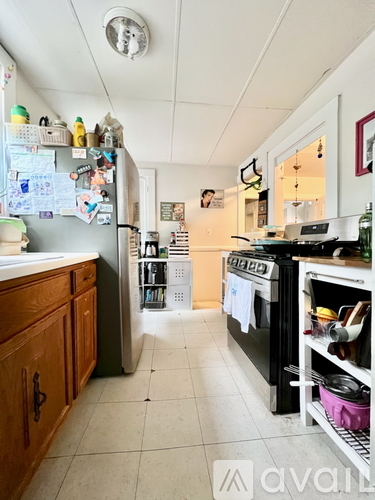 A kitchen with a black oven and a white fridge.