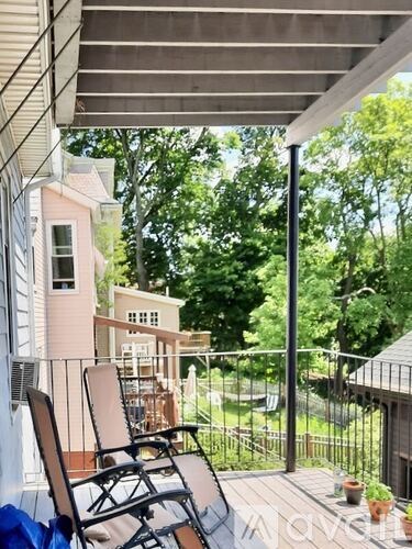 A patio with a chair and a table is shown.