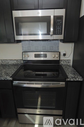 A modern kitchen with a stainless steel oven and microwave.