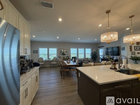 A modern kitchen with a large island and a dining area.