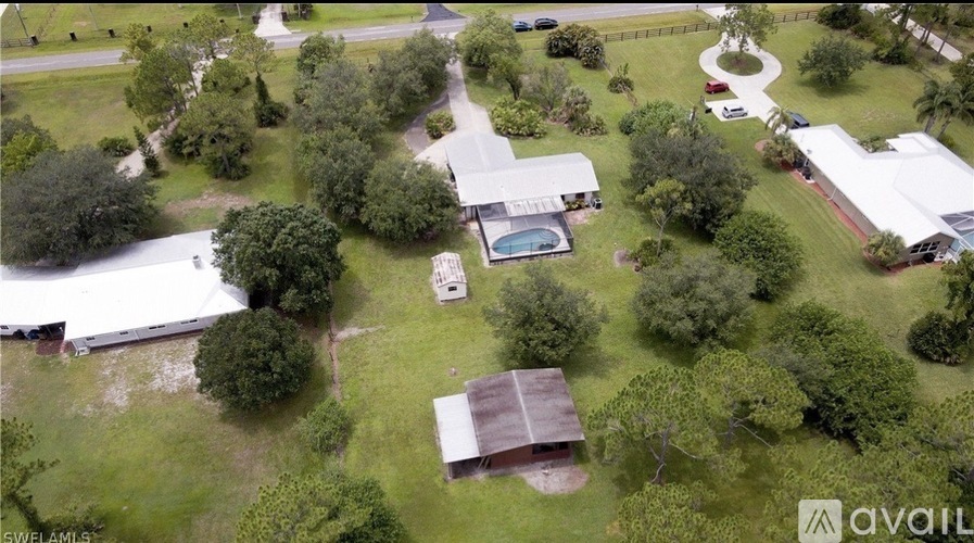 A bird's eye view of a property with a swimming pool and a shed.