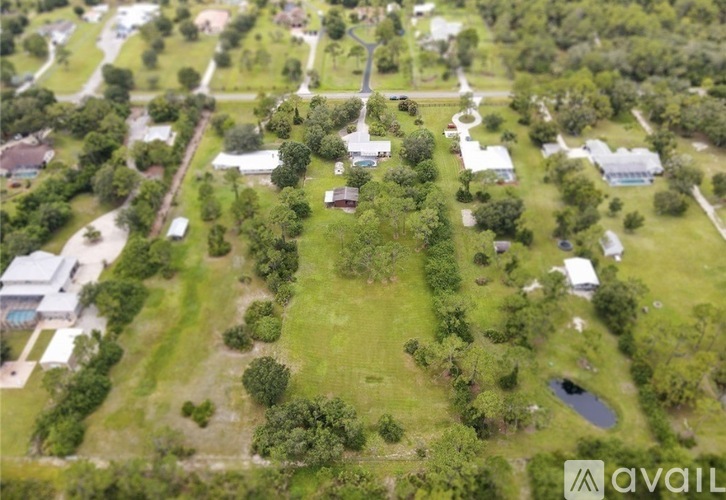 A bird's eye view of a residential area with houses and greenery.