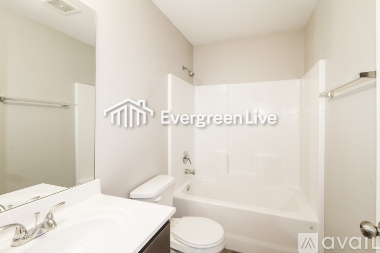 A white bathroom with Evergreen Live logo.