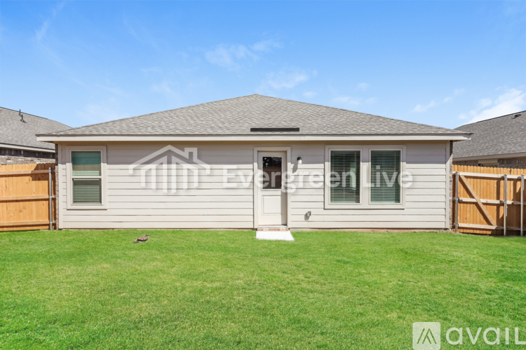 A house with a grey roof and a white front door is for sale.