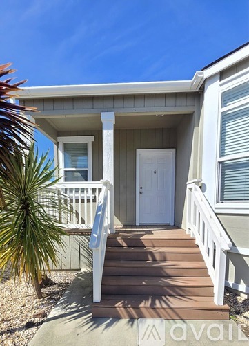 A house with a white door and a porch.