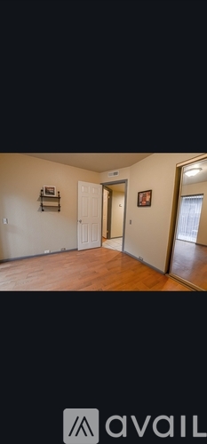 A room with wooden floors and white walls.