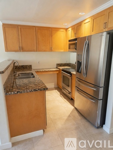 A kitchen with wooden cabinets and stainless steel appliances.