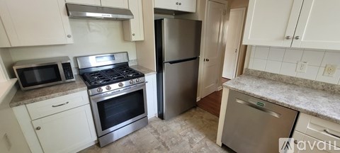 A kitchen with a stove top oven and a microwave.