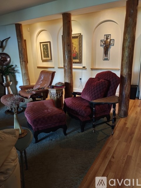 A living room with two chairs and a table.
